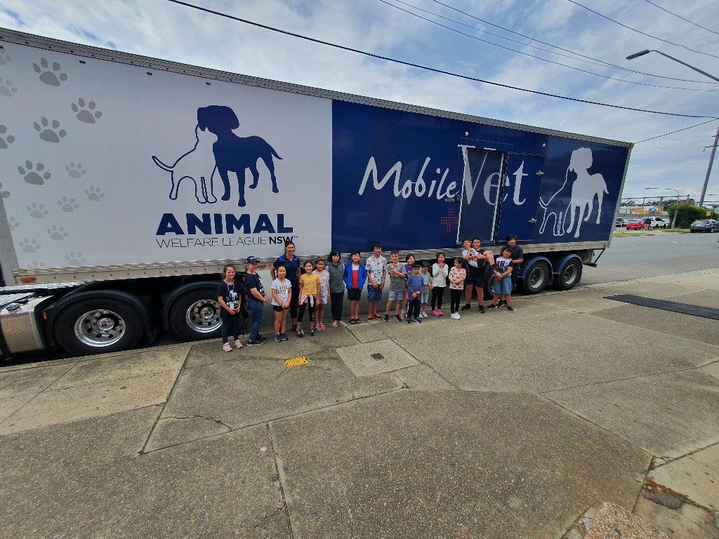 AWL mobile vet truck group of kids