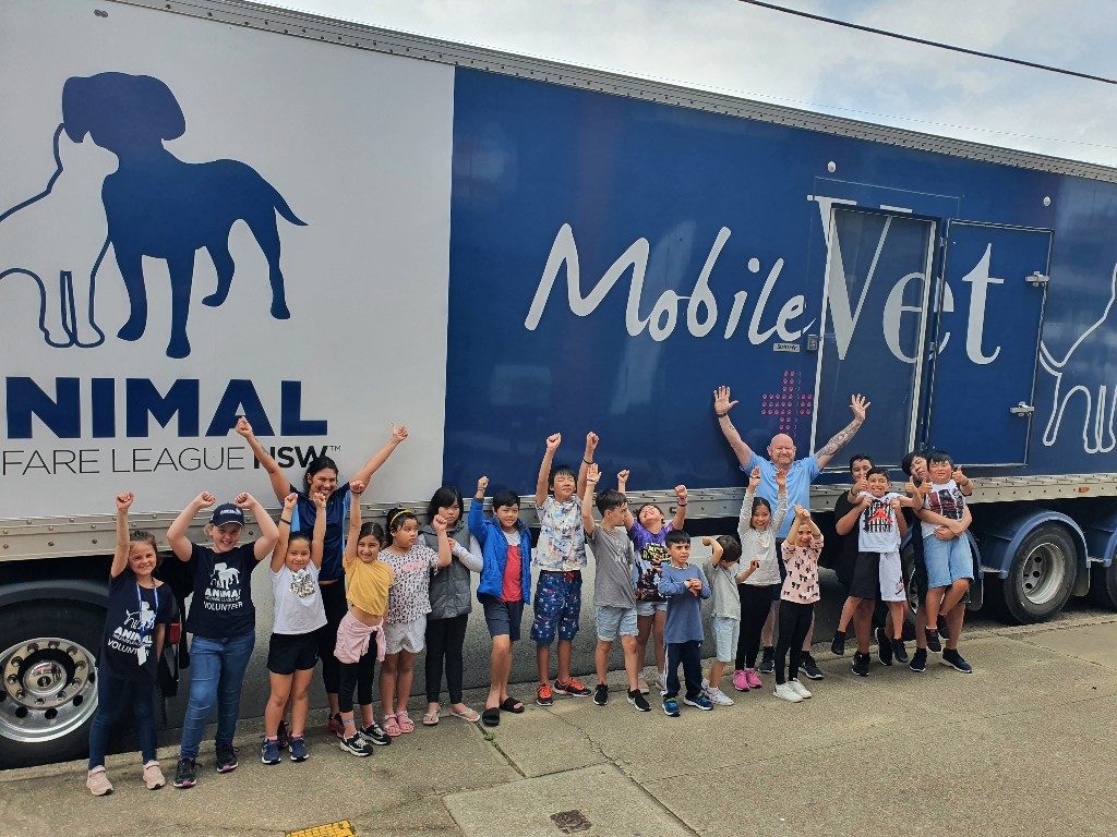 Children outside AWL mobile vet truck